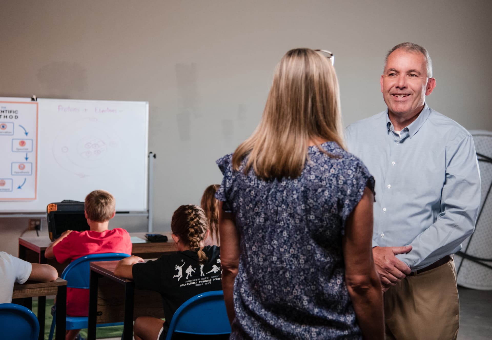 Scott Alexander visiting with a teacher in an Indiana classroom